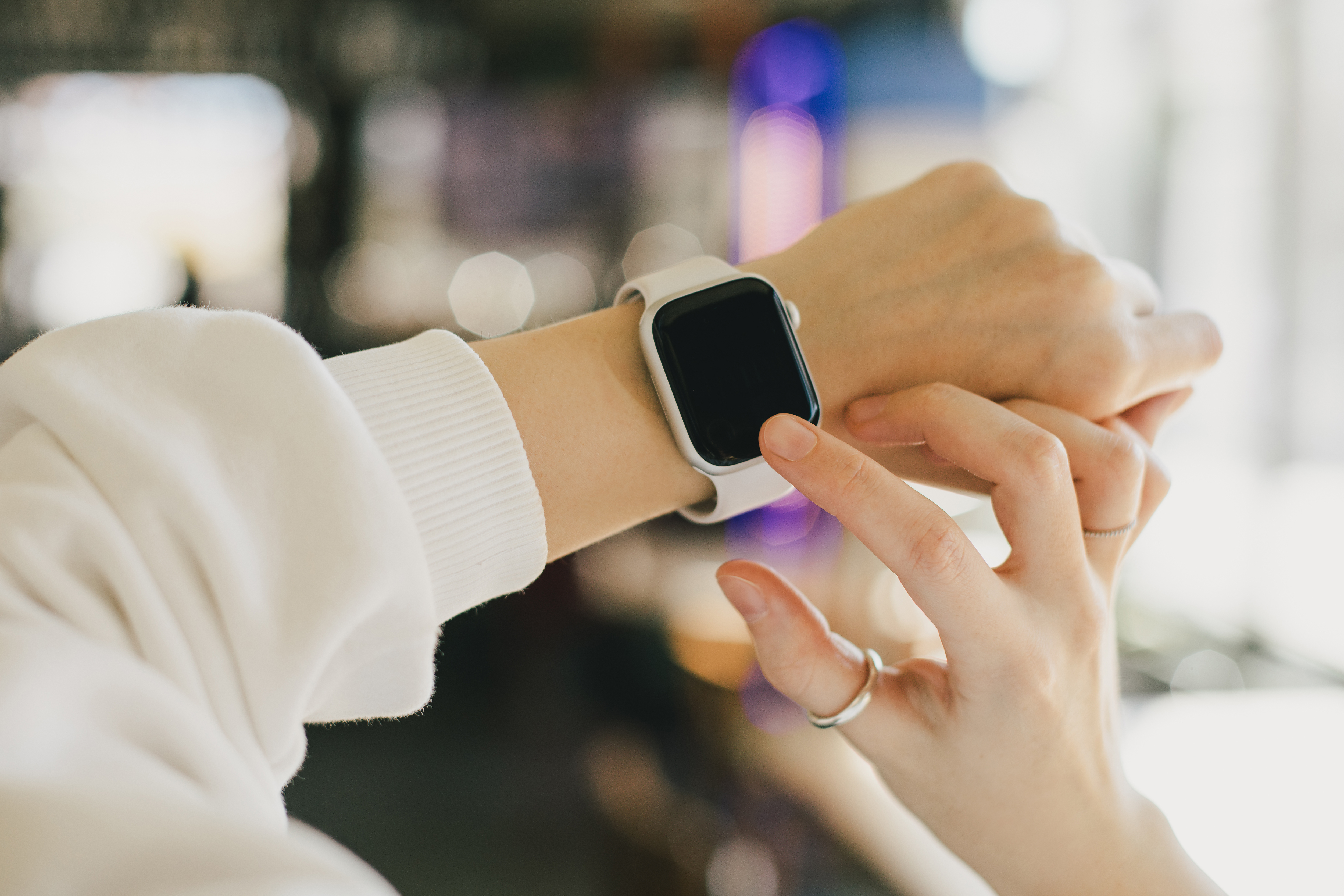 Woman uses a smart watch.